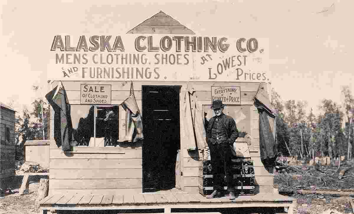 Anchorage. Man in front of Anchorage Clothing Store, between 1900 and 1916