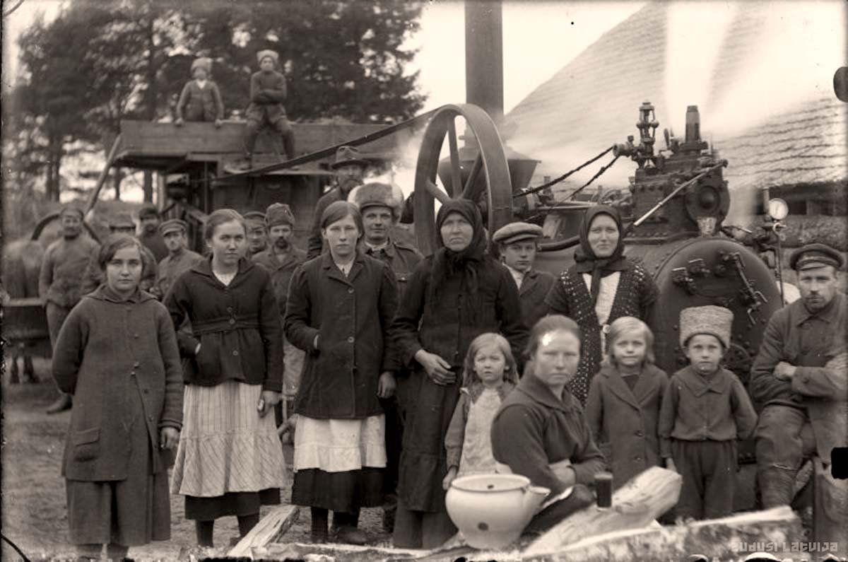 Madona. Agricultural work, in the background - a steam thresher