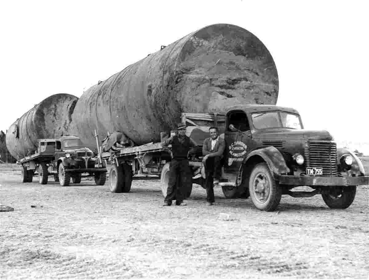Two large tanks on two trucks