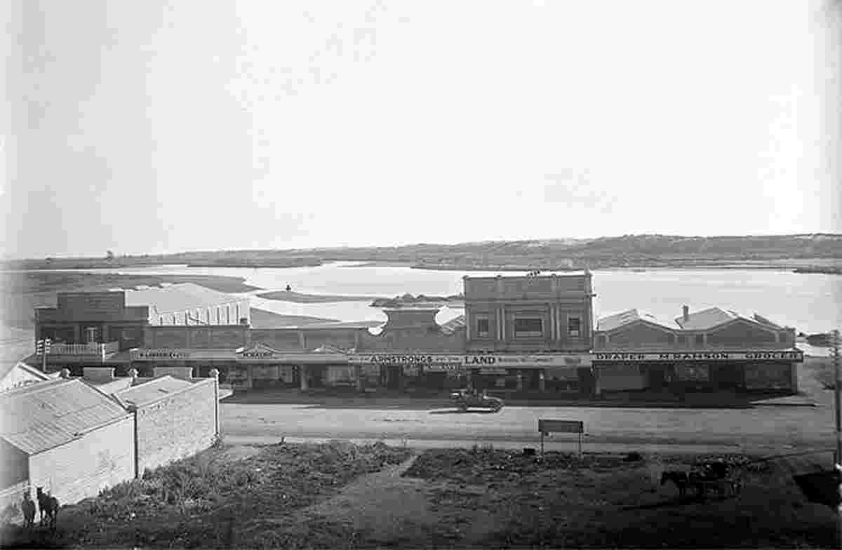 Whakatane. View of street with shops and river